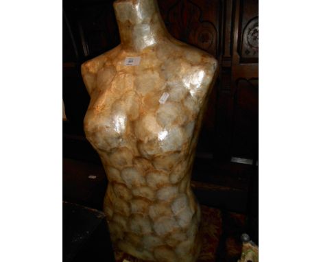 A female torso mannequin covered with shell 