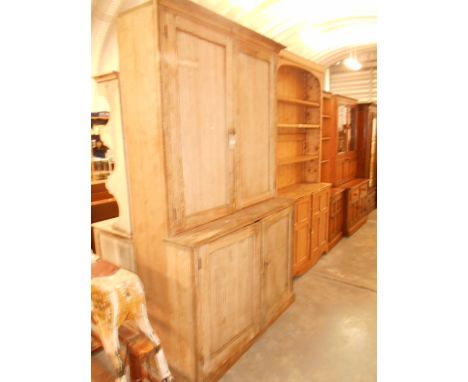 A vintage oak cupboard the top having four shelves and pigeon holes with double cupboard under 215cm high x 133cm wide x 52cm