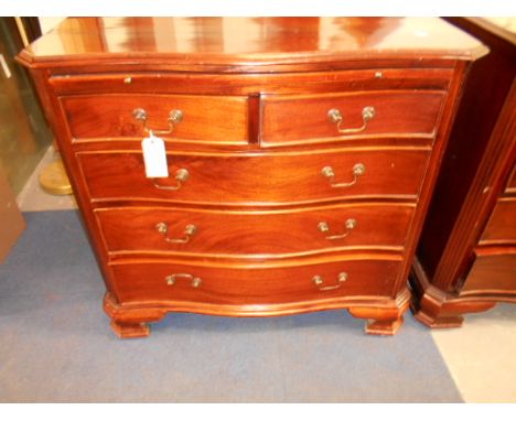 A late-20th C mahogany chest the serpentine top with canted corners over brush slides and two short over three long graduatin