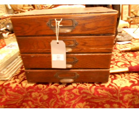 A set of four vintage wooden filing drawers