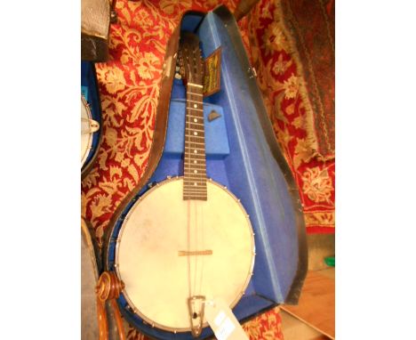 A vintage 1920's banjo in case with mother of pearl inlay to fret-board and signature and date to back