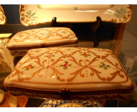 A pair of Limoges decor main trinket boxes with hand-painted, gilt and floral decoration