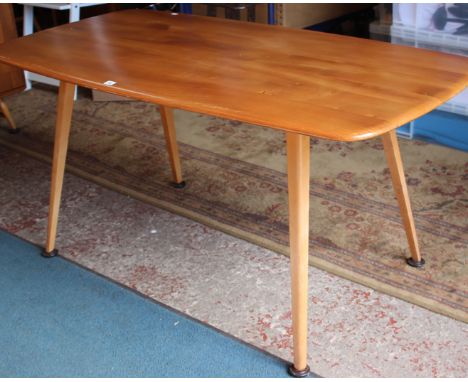 An Ercol elm dining table with a set of six dining chairs 