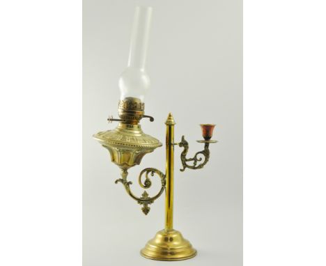 Brass lamp, twin scrolled branches, one with an oil lamp, the other with a candle sconce, circular base, oil lamp with chimne