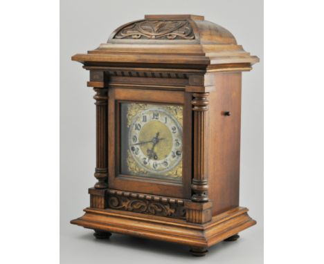 19th Century German walnut cased bracket clock, carved domed top, brass plate with circular silvered dial, eight day movement