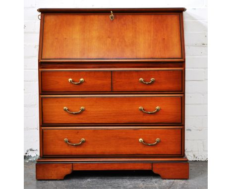 Reproduction walnut effect bureau, fall front enclosing a fitted interior, two short and two long drawers, bracket feet, widt