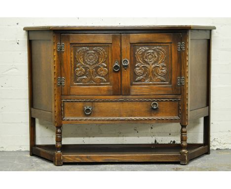 Oak side cabinet, with two carved panel doors above a drawer, turned legs joined by a shelf, width 120cm, depth 36cm, height 