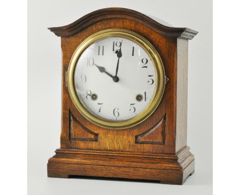 Edwardian oak mantel clock, domed case, bracket feet, 6" diameter and circular enamelled dial, marked made in USA, American m