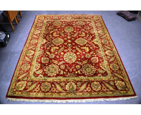 Persian pattern carpet, red ground, meandering floral borders, 320cm x 240cm.