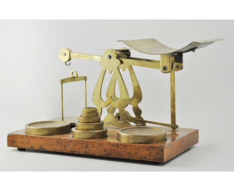 Set of inland letter post and parcel scales, brass frame, with a set of graduating weights, mahogany plinth, length 42cm