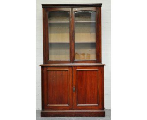 Walnut bookcase, associated upper section with glazed doors enclosing two shelves, base with rectangular top and moulded edge