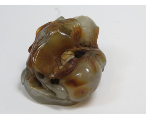 An agate carving19th centuryof mottled brown tone and boulder form, carved as a fruiting lotus plant, 6 cm wideFor further in