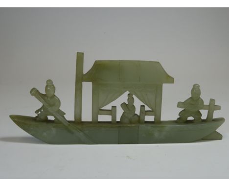 A Jade Pleasure Boat19th centuryof veined green tone and of flattened form, carved with a seated lady under a canopy and two 