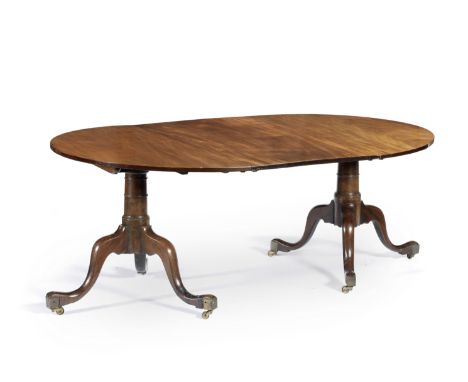 A mahogany twin-Pedestal Dining TableIn the George II style With D-shaped ends and an additional leaf on turned supports on d