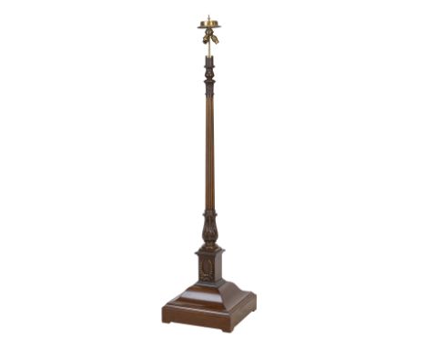 An early 20th century mahogany and brass standard lampFitted with three light fittings, raised on a fluted column on moulded 