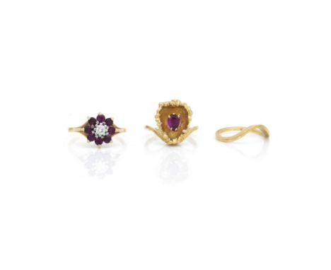 A ruby and diamond cluster ring and a suite of two ringsComprising: an 18ct gold mounted floral cluster ring, claw set with a