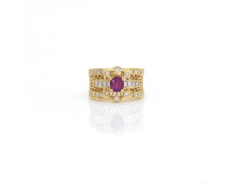 A ruby and diamond ringDesigned as a pierced broad band, with central claw-set oval-cut ruby, approximately measuring 5.45 x 