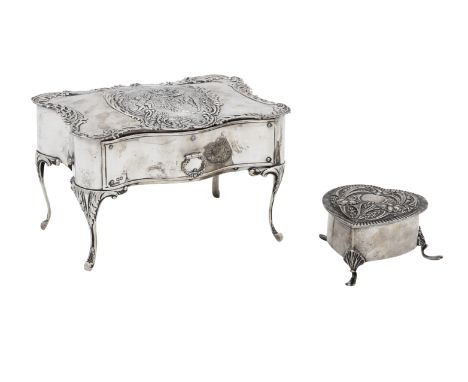 An Edwardian rococco silver jewellery casket,maker's mark WC, London, 1901, formed as a dressing table, on four elongated lea