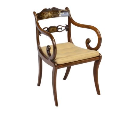 A Regency rosewood and brass inlaid elbow chairWith curved and shaped top and mid rail, above a caned seat with deep buttoned