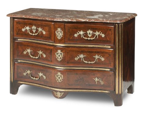 A French Régence walnut, brass-mounted and crossbanded commode, early 18th centuryThe serpentine marble top with moulded edge