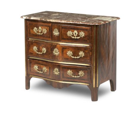 A French Régence walnut, crossbanded and brass mounted commode, early 18th centuryThe moulded marble serpentine top over thre