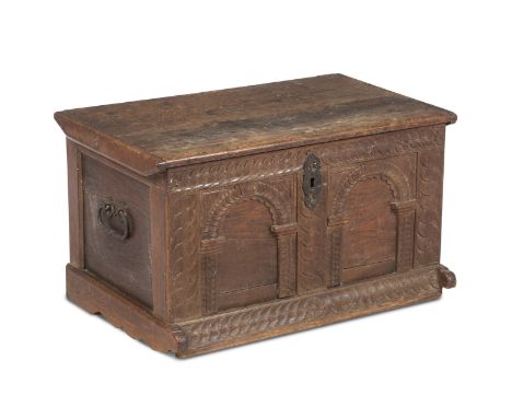 An 18th century and later oak cofferWith double arcaded front and hinged lid, rasied on bracket feet, 78cm wide, 50cm deep, 4