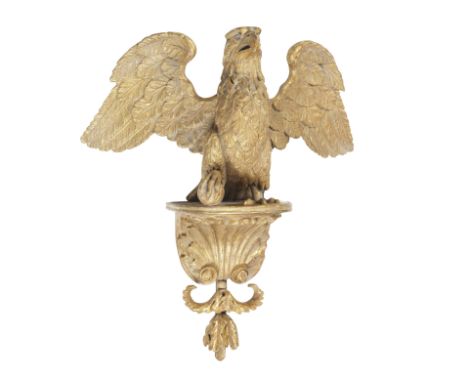 A 19th century giltwood and gesso eagle wall bracketCarved with its leg grasping a ball, 45cm wide, 25cm deep, 55cm high (17 