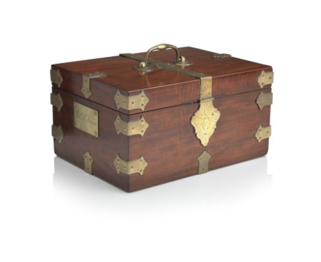 A George III mahogany and brass bound campaign strong boxOf rectangular form with brass mounts, and swing handle with applied