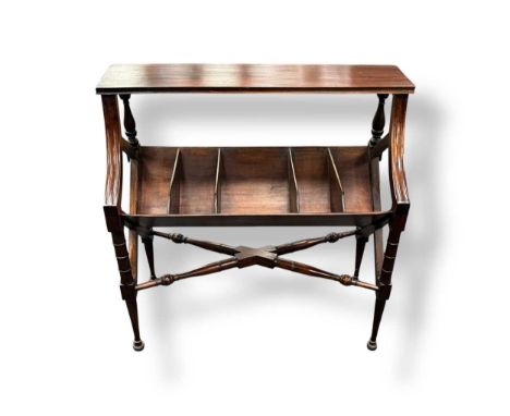 Mahogany two tier book trough or stand, the narrow upper shelf with downswept support over a mid section fitted with five div