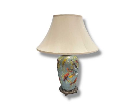 A large glass vase shaped lamp decorated with parakeets and fauna on a blue ground, 75cm high including shadeAppears to be in