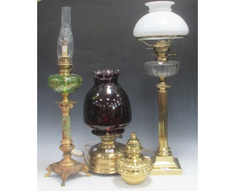 A tall brass column lamp with cut clear glass oil reservoir and white opaline shade (untested), 83cm high, a short brass oil 