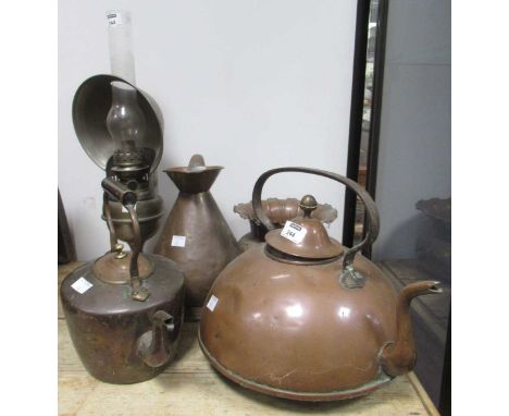 A copper kettle, another, a half-gallon copper jug, a hammered copper vase, and a seamstress' oil lamp