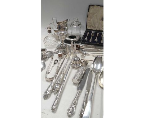 A collection of silverware including flatware, glass oil bottles and conserve jar with silver covers, cream jug, candle snuff