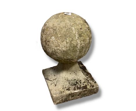 A pair of composition stone gate post finials in the form of balls, together with an urn55 x 32 x 32cm, the finial in the mai