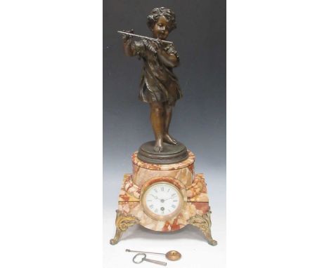 An early 20th century spelter and marble figural mantel clock, the white enamel dial with Roman numerals, the rouge marble ca