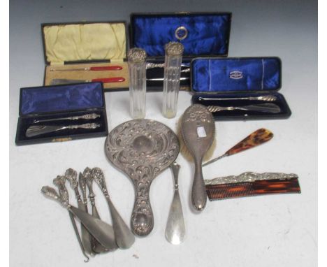 Quantity repousse silver: a collection of button hooks and shoe horns, together with part dressing set to include mirror, dre