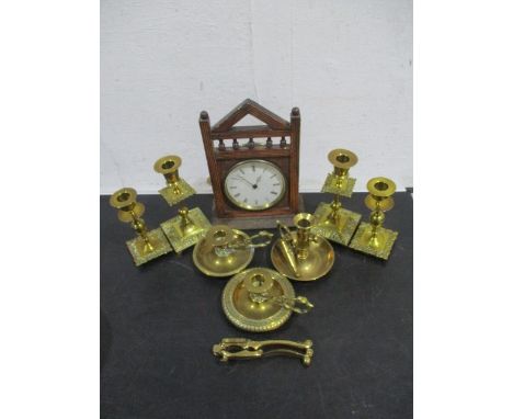 Two pairs of brass candlesticks, along with three brass chamber sticks, nutcracker and gothic mantle clock.