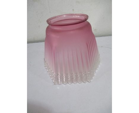 A cranberry glass oil lamp shade