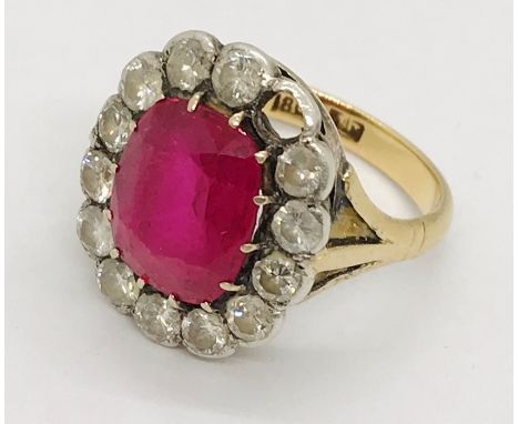 A ruby and diamond cluster ring ( 1 diamond missing), the central ruby measures approx. 12mm x 9mm, each diamond is approx. 3