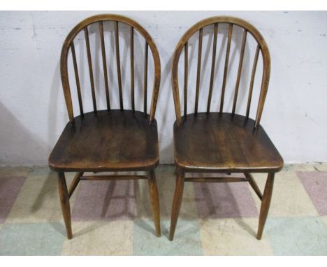 A pair of Ercol stick back dining chairs