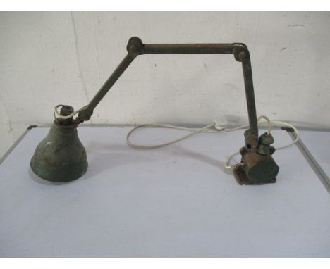 A vintage industrial wall mounted green anglepoise lamp