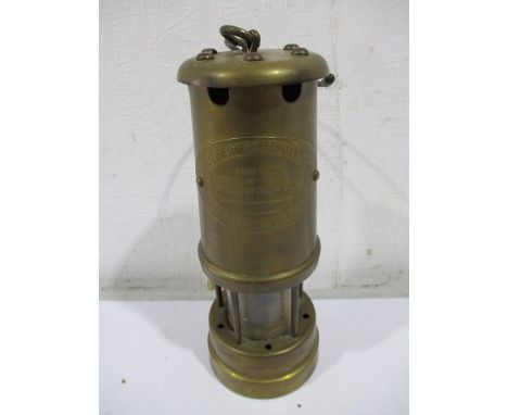 A Vale type brass miners lamp, plaque to front "British Coal Mining Company, Wales UK"