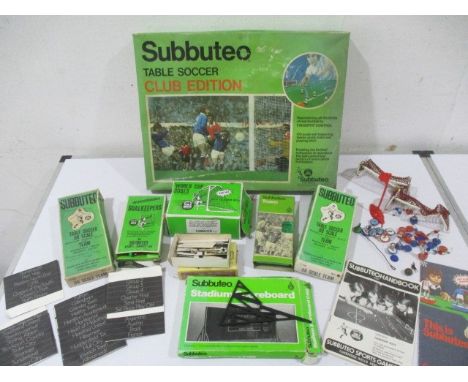 A boxed Subbuteo table soccer club edition set, along with accessories including stadium scoreboard, goals, boxed teams, inte