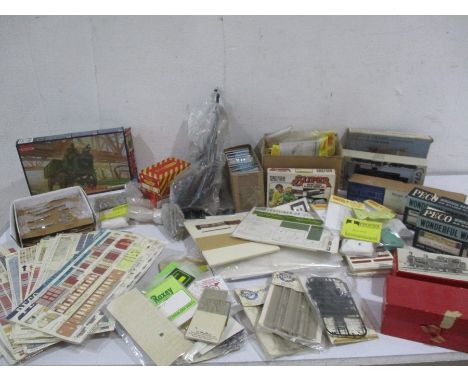 An assortment of OO gauge model railway locomotives, kits and accessories including bogies, carriage sides, window panes etc.