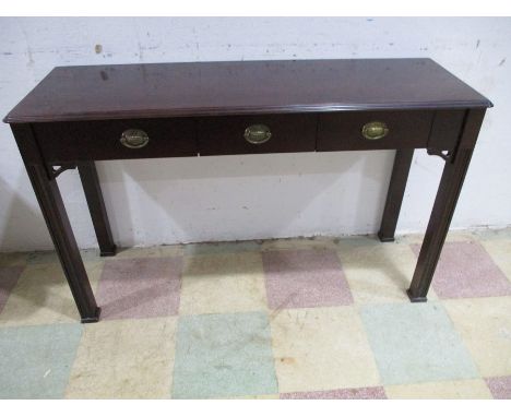 A modern dark wood buffet with three drawers