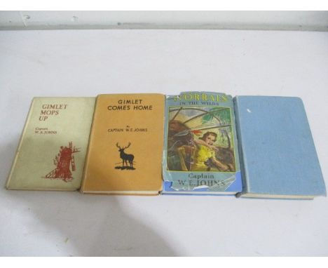 A collection of four books by Capt. W E Johns. Worrals carries on  in hardback cover and Worrals in the wilds (first edition)