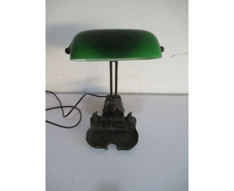 A bankers style lamp with figure group under