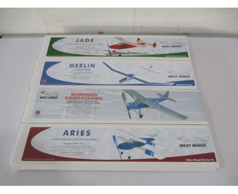 A collection of four boxed West Wings model kit planes including Jade, Aries, Merlin and De Havilland Puss Moth.