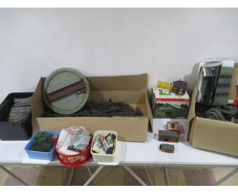A collection of model railway accessories including building, tri-ang track, platforms, signals, trees, power units etc