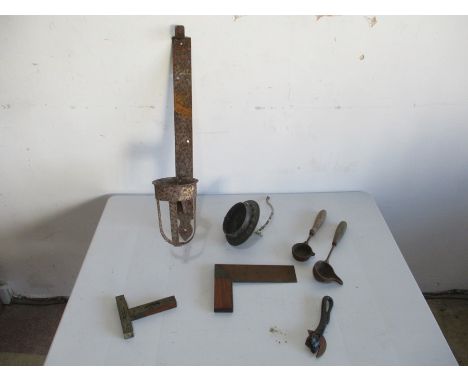 A small collection of tools including level, square and ladle